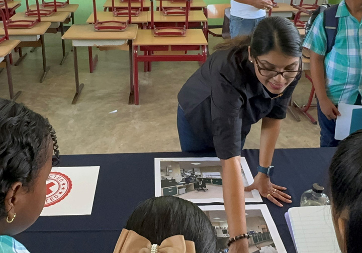 An Intertek employee talks to school children. 